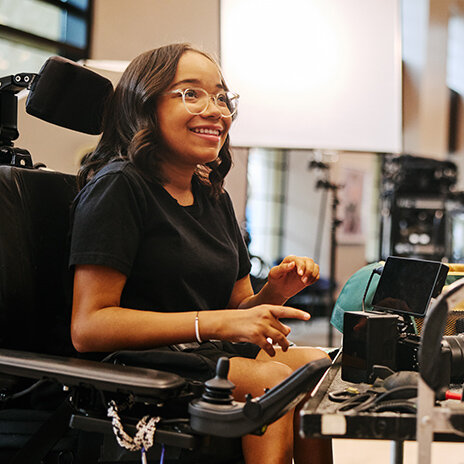 SMA advocate in wheelchair with photography equipment
