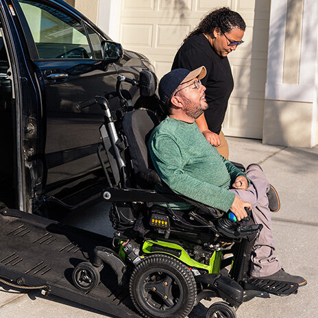 SMA advocate in wheelchair exiting vehicle using ramp