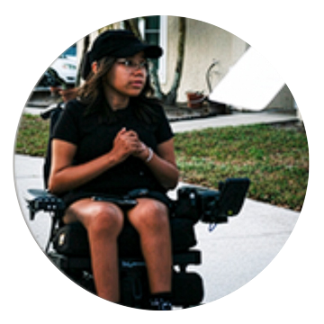 SMA advocate sitting in a powered wheelchair
