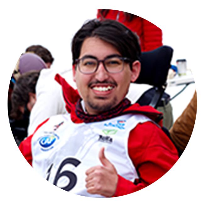 SMA Patient Advocate in wheelchair wearing a racing bib and celebrating with a thumbs up